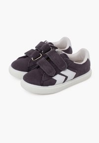 Gray suede sneakers with white accents, featuring twin Velcro straps and a textured white rubber sole. Rounded toe and cushioned interior.