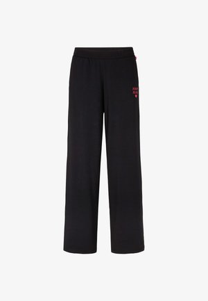 Czarne dresy z elastycznym pasem. Na przodzie znajduje się małe czerwone logo z napisem. Wykonane z miękkiego materiału o luźnym kroju.