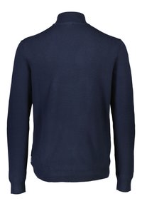 Navy sininen vetoketjullinen neule, ribattu kaulus ja hihansuut, kudottu pinta, yksinkertainen muotoilu ilman kuvioita ja sivulappu yksityiskohtana helmassa.