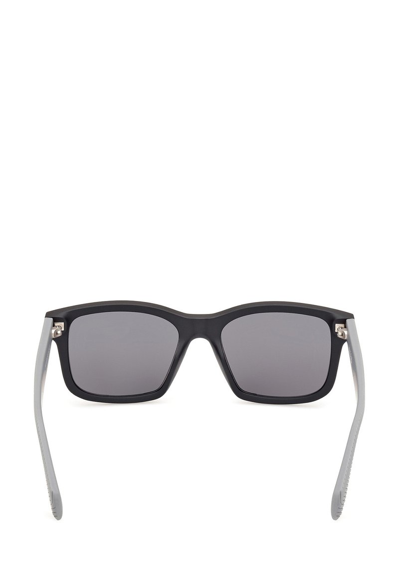Black matte square sunglasses with dark tinted lenses and gray temples. Features metal accents on the frame's hinge.