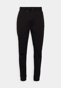 Black joggers featuring a drawstring waistband, slim fit, ribbed cuffs, and a side pocket with a logo patch. Soft cotton blend material.