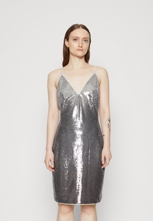 Silver sequin dress with a V-neckline, thin straps, form-fitting design, knee-length, and smooth texture.