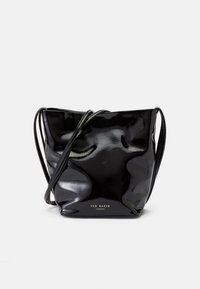 Black patent leather bucket bag with soft, wrinkled texture, adjustable shoulder straps, and embossed logo on the front.