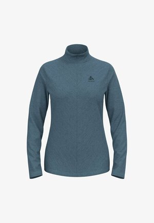 Langarmtop in blauw-grijze gestructureerde stof, met een hoge kraag en een subtiel chevronpatroon. Logo op de borst weergegeven.