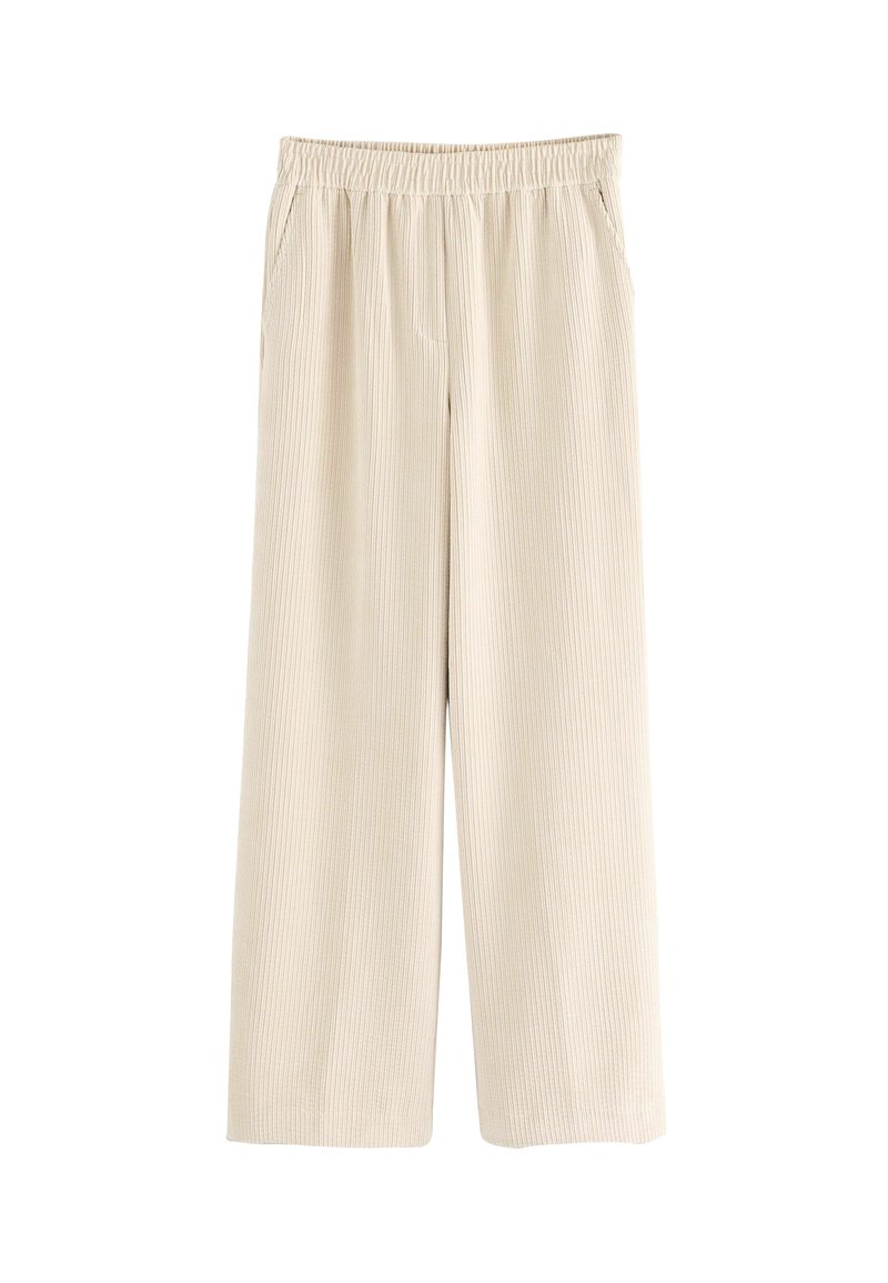 Pantaloni beige a gamba larga con una texture a costine, vita elastica e tasche laterali oblique. Tessuto morbido in un design leggero.
