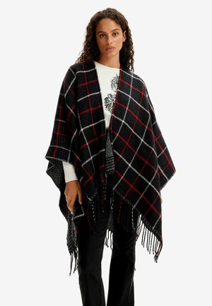 Poncho a quadri nero, rosso e bianco con dettagli frangiati. Materiale morbido, design aperto e vestibilità morbida per comfort e sovrapposizione.