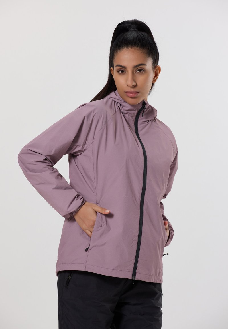 Lättviktsjacka med huva i ljuslila med framdragkedja, sidofickor och svarta detaljer längs dragkedjan och ärmsluten. Matt yta.
