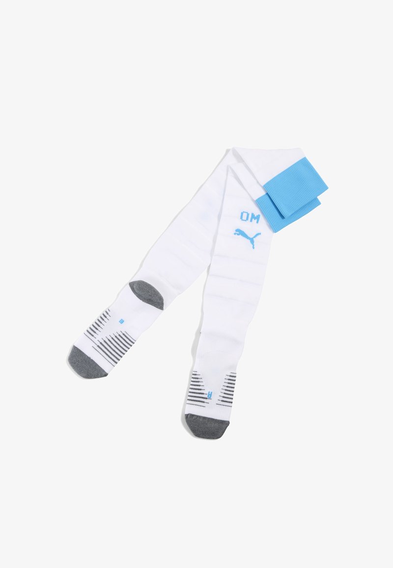 Calze da calcio bianche con accenti blu, dotate di un bordo a coste, suola grigia a righe e logo OM. Realizzate in materiale sintetico.