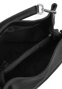 Black leather handbag interior with two zippered compartments, fabric lining, and an adjustable shoulder strap with silver hardware.