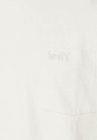 Hvid bomulds T-shirt med en frontlomme med prægede "Levi's" logo. Blød tekstur med en standard rund hals design.