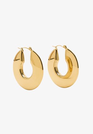 Złote kolczyki w kształcie dużych, owalnych obręczy o polerowanym wykończeniu i małym zawiasie do zamykania.