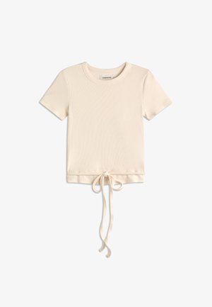 Top crema a maniche corte in maglia a costine con scollo rotondo e dettaglio annodato sul davanti che pende dall'orlo.