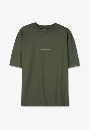 Olive green cotton t-shirt with short sleeves, featuring a simple, central "PEGADOR" logo in contrasting text. Classic crew neck design.