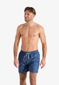 Blauwe zwemshorts met een palmbomenpatroon, elastische tailleband en trekkoord. De stof lijkt lichtgewicht; geschikt voor strandkleding.