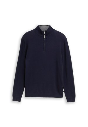 Pullover navy in morbido tessuto a maglia, presenta una mezzazip, colletto alto e maniche lunghe, con una texture a coste su polsi e orlo.