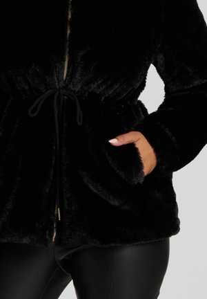 Black faux fur jacket with a zippered front, adjustable drawstring waist, and side pockets. Soft texture with a plush appearance.
