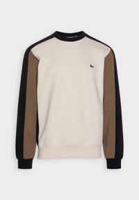 Beige sweatshirt met ronde hals, zwarte en bruine lange mouwen en klein groen krokodillenlogo op de linkerborst.