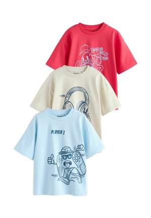 Three graphic t-shirts: a red shirt with a skull design, a cream shirt with a headphone graphic, and a light blue shirt with a game controller.