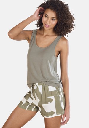 Olive green tank top made of soft fabric paired with light shorts featuring a bold white and olive pattern, elastic waistband, and relaxed fit.