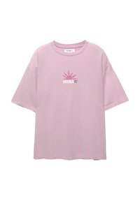 Lys pink oversized t-shirt lavet af bomuld, med et grafisk design af en sol og "IBIZA 91" trykt på forsiden i kontrastfarver.