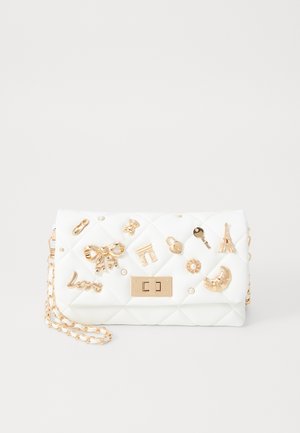 White quilted handbag featuring gold-tone decorative charms, a chain strap, and a front clasp. Smooth texture with embellished accents.