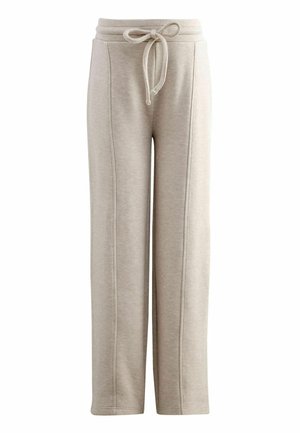 Ljusbeige sweatpants med dragsko i midjan, vid benöppning och vertikala sömdetaljer. Mjuk textur, idealisk för avslappnad användning.