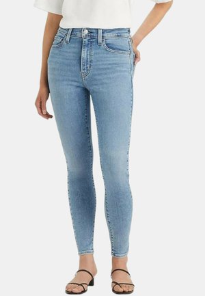 Jeans skinny a vita alta di colore blu chiaro in denim, dotati di cinque tasche, leggere sfumature e chiusura con bottone frontale.