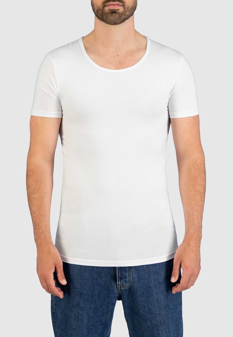 White short-sleeve t-shirt with a rounded neckline, made of soft, stretchy fabric. Fitted design accentuates body shape.