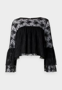 Blusa nera con maniche a campana lunghe, caratterizzata da un corpino a coste testurizzate e un soprabito in pizzo floreale trasparente. Collo tondo e chiusura con bottoni sul retro.