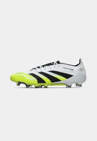 White and neon yellow Adidas Predator soccer cleat with black stripes, laces, and studded sole on a plain background.