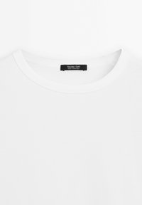 White crew neck t-shirt with a black label reading "Massimo Dutti Made in Portugal" sewn inside the neckline.