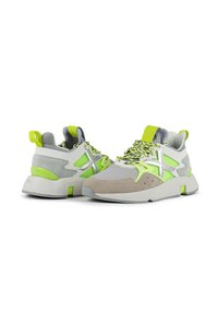 Sneakers with a mix of gray, green, and beige materials. Features a textured mesh upper, suede accents, and a chunky white sole.