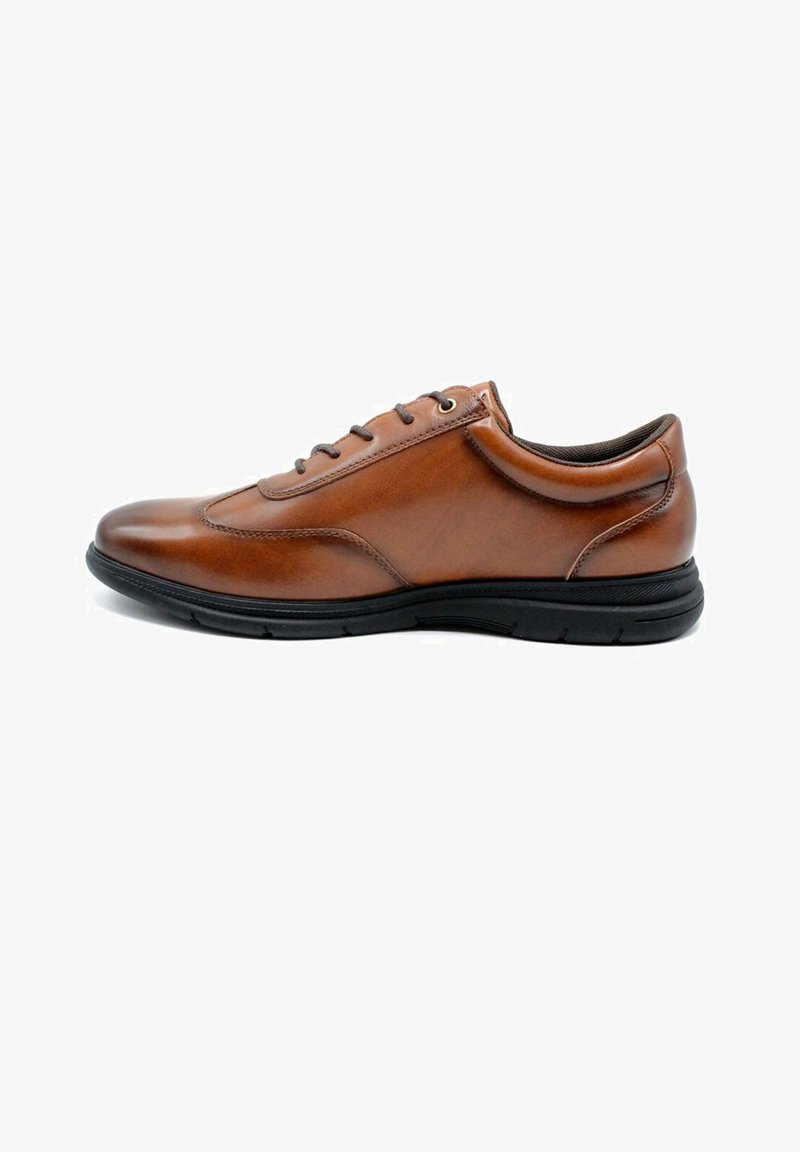 Chaussure en cuir marron avec une finition lisse, bout rond, semelle en caoutchouc noir, design à lacets et détails de couture subtils.