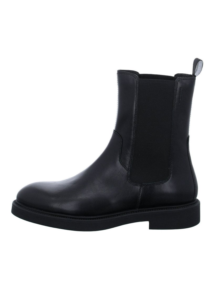 Bottine Chelsea en cuir noir avec panneau latéral élastique, languette à l’arrière, talon bas et bout arrondi.