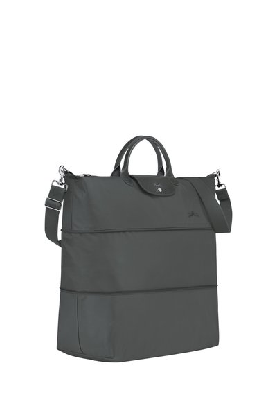 Dark gray nylon tote bag with dual top handles and adjustable shoulder strap, featuring a snap closure and textured accents.