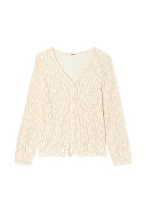 Cardigan en dentelle couleur crème à manches longues, col en V, avec petits boutons à l'avant, posé à plat sur un fond blanc.