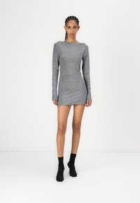 Grå, glitrende langermet kjole med båtutringning og figursydd silhuett. Har rynkedetaljer og kort hemline.