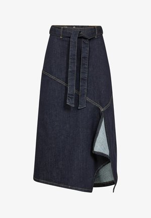 Denim wrap skirt in dark blue with a tie waistband, angular seams, and a side slit featuring light blue fabric beneath.