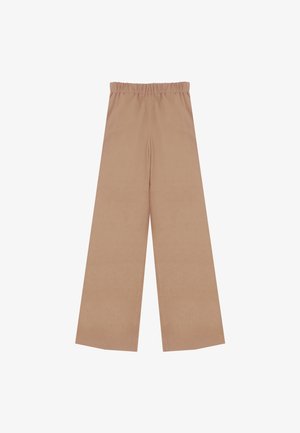 Pantalons larges beiges avec une taille élastique, fabriqués en tissu doux, présentant une surface lisse et sans motifs ni embellissements.