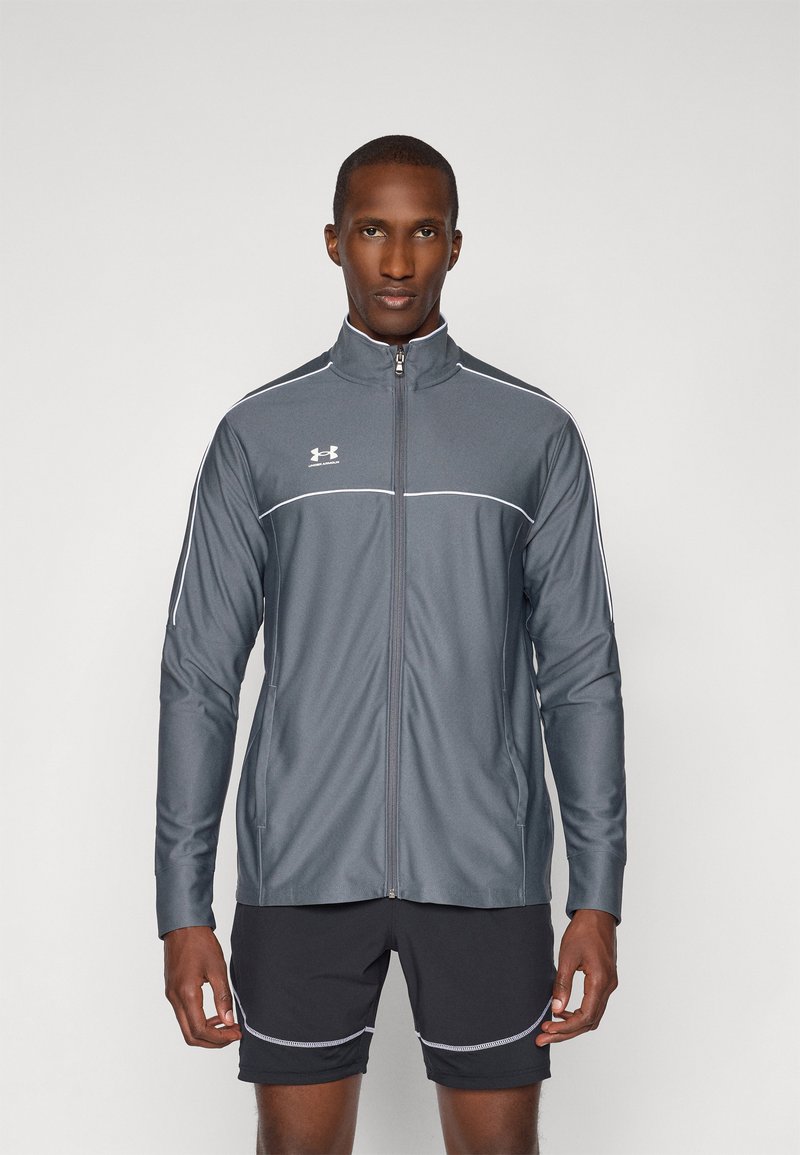Gray zip-up athletic jacket with white accents and long sleeves, made of a smooth, moisture-wicking material. Worn over dark shorts.