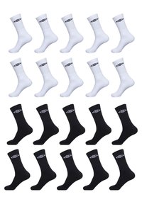 Chaussettes blanches et noires disposées en rangées. Les chaussettes blanches présentent un haut côtelé et un logo noir. Les chaussettes noires ont une texture lisse et un logo blanc.