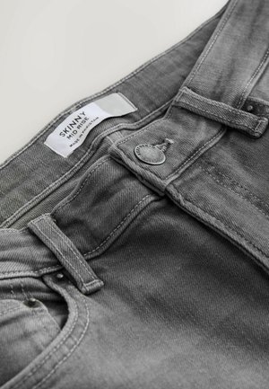 Graue Skinny-Jeans mit mittlerer Taille, aus Denim gefertigt. Merkmale sind ein Knopfverschluss, Gürtelschlaufen und gestickte Akzente.