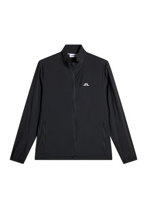 Musta kevyt vetoketjullinen takki, jossa on pystykaulus, kaksi vetoketjullista sivutaskua ja pieni valkoinen logo vasemmalla rinnalla.