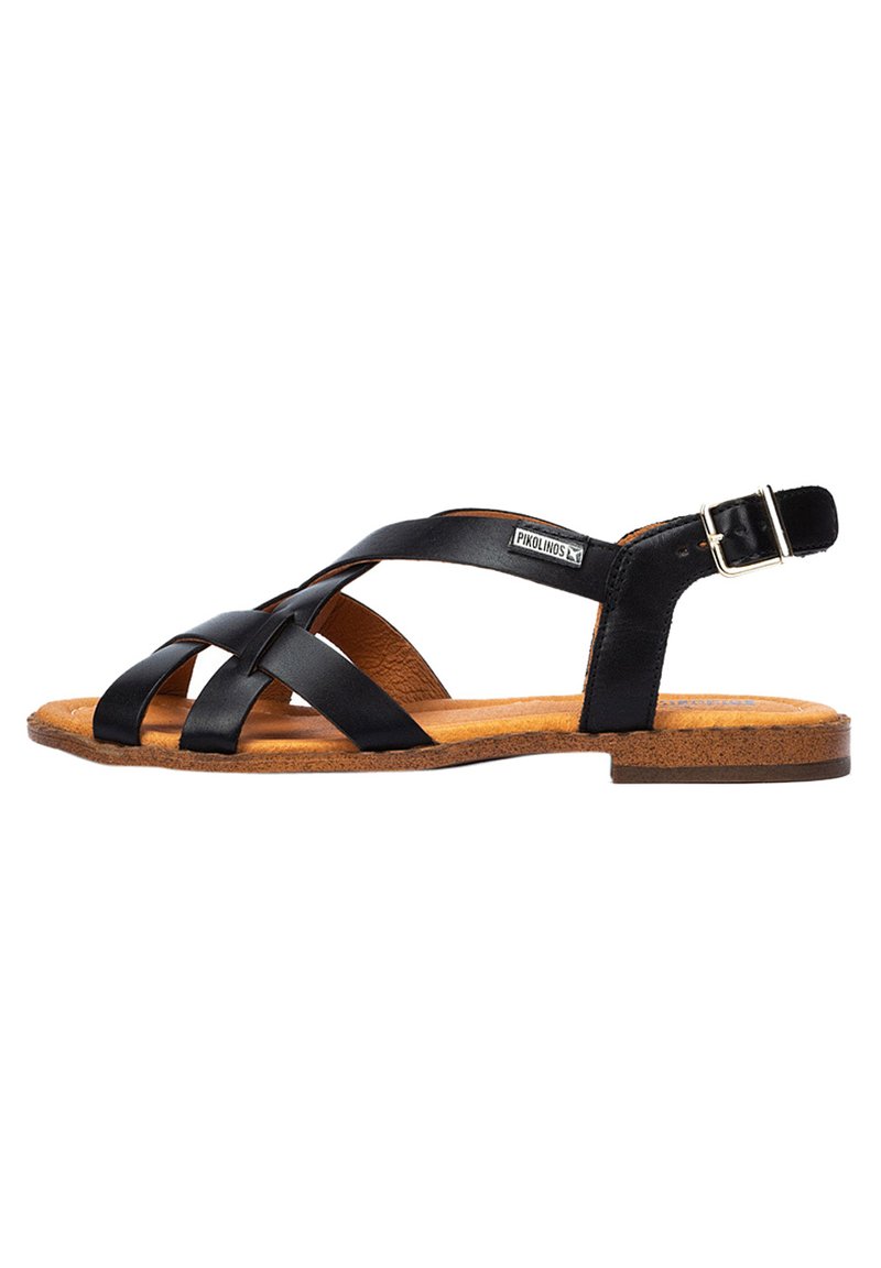 Zwarte lederen sandaal met kruislings gespen, verstelbare enkelband, kurken zool en een geprofileerde binnenzool voor extra comfort.