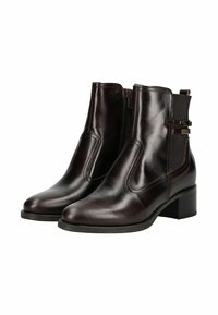 Bottines en cuir marron avec un talon bloc, fermeture zippée sur le côté et panneaux élastiques. Présente une sangle décorative avec des éléments en métal.