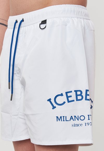Shorts de bain blancs avec cordons de serrage bleus et logo imprimé, dotés d'un tissu lisse et d'une taille plate avec une boucle décorative.