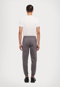 EA7 Emporio Armani TRAIN CORE PANTS - Spodnji deli trenirk - volcanic glass