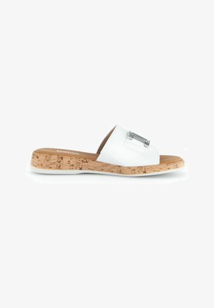 Chanclas blancas con suela de corcho, que presentan un diseño plano y un acento metálico rectangular en la correa. Textura suave.