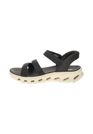 Sandalia negra de punta abierta con tres correas ajustables y una suela blanca gruesa con múltiples agujeros de ventilación.