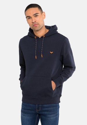Navy hooded sweatshirt with orange drawstrings, front pocket, and logo detail. Made of soft fabric with a relaxed fit.